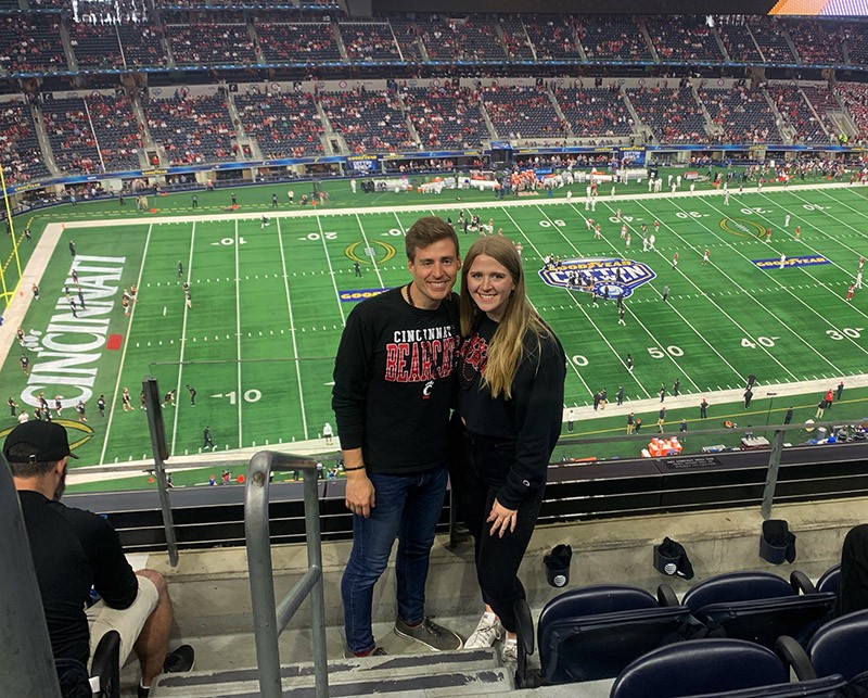 Abby Revetta and partner pose at the Cotton Bowl football game between the Cincinnati Bearcats and the Alabama Crimson Tide