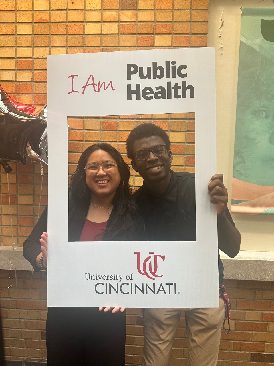 Mentor and mentee pair posing with public health sign