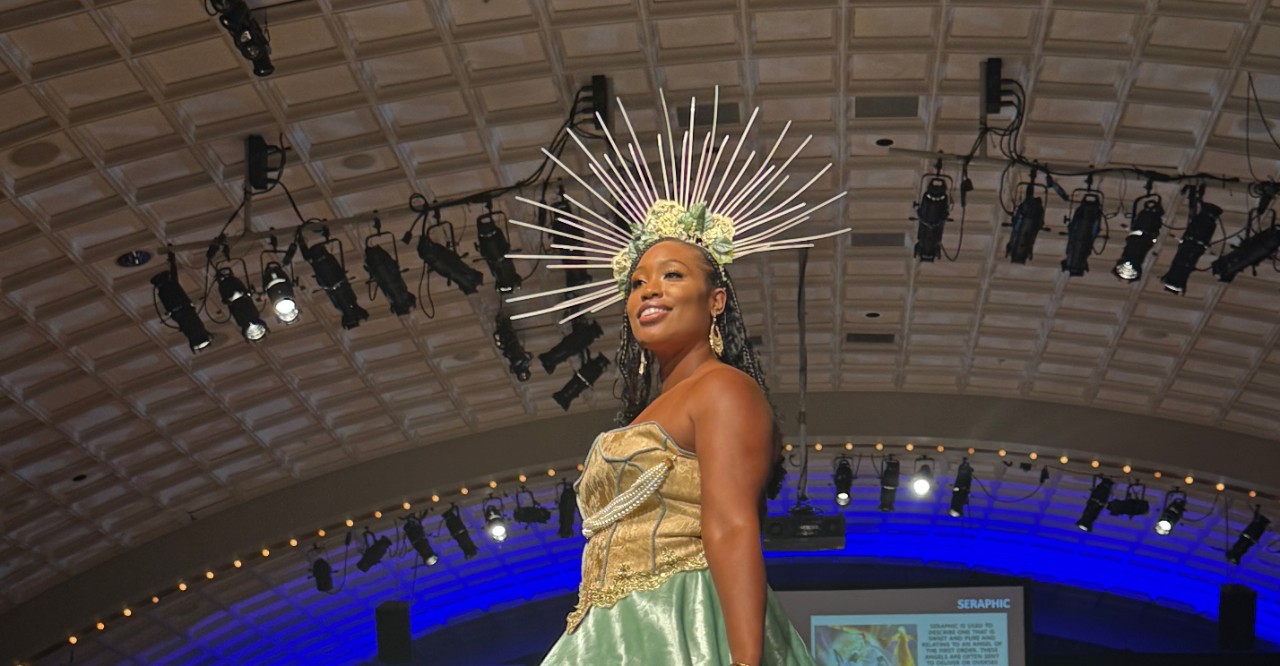 Fashion design student on the runway with crown made of thrifted objects