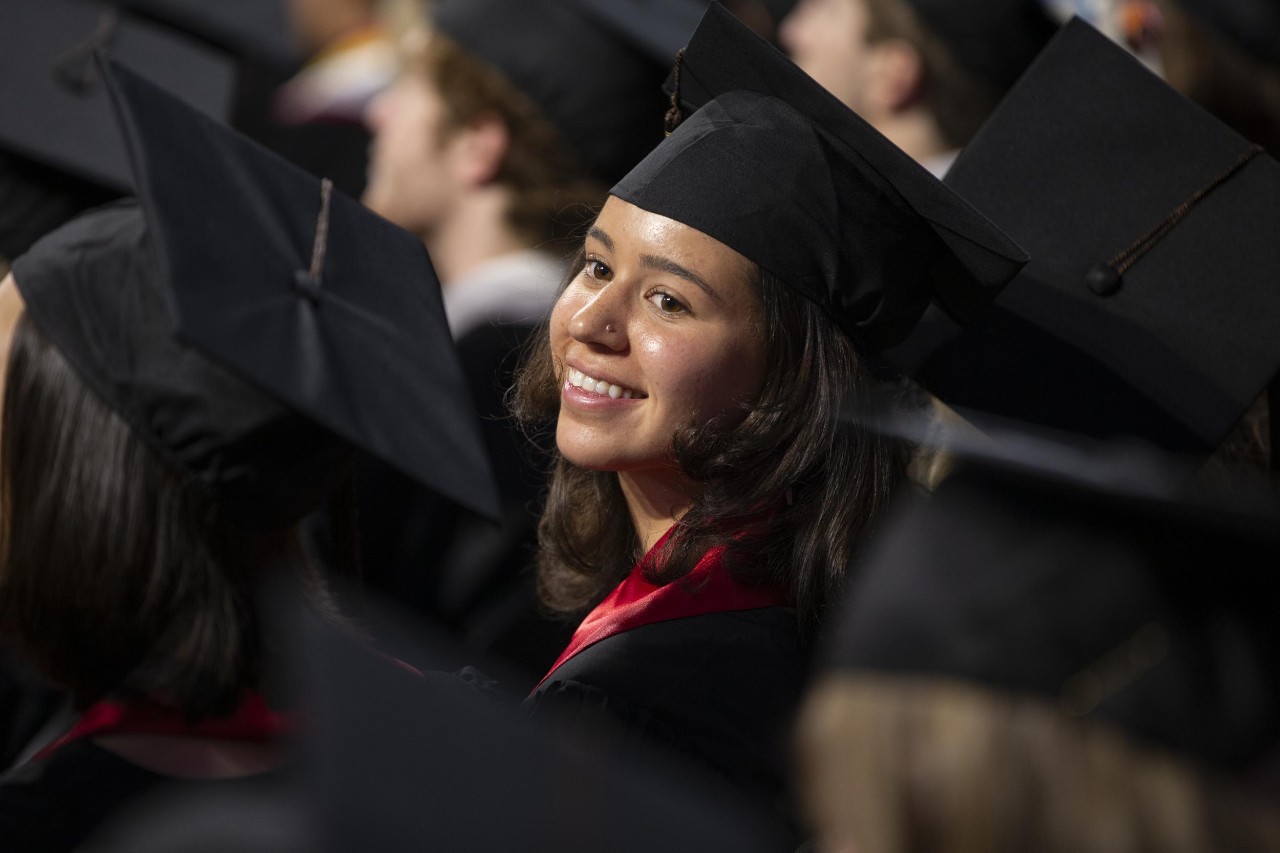 Student smiles at her graduation ceremony