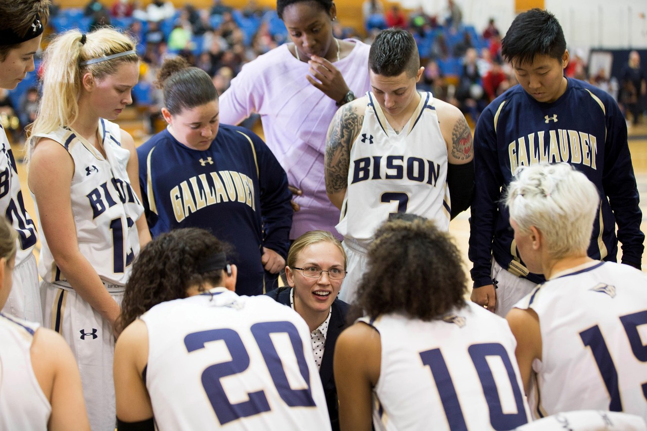 Gallaudet coach Stephanie Stevens communicates with her team during a timeout.
