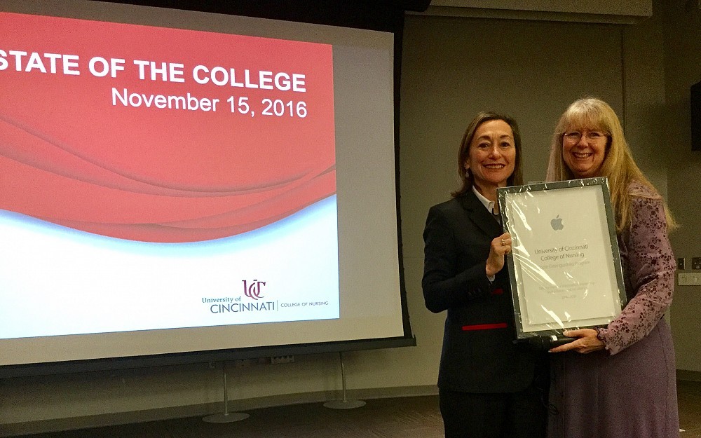 Greer Glazer, PhD, dean UC College of Nursing and Anne VanMiddlesworth, development manager for Apple with the Apple Distinguished Program Award preented to the College of Nursing for 2016-2017 and 2017-2018