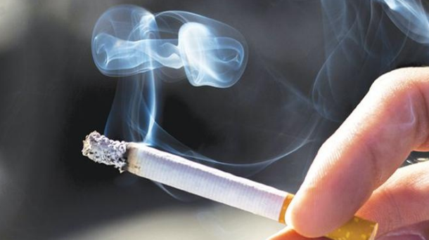 person holding cigarette