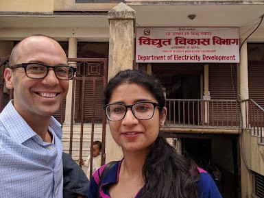 Patrick Ray and Asphota Wasti smile for the camera in front of a