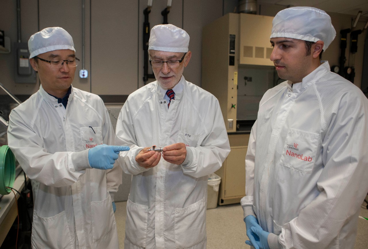 Left to right Daewoo Han, PhD student, UC professor Andrew Steckl, PhD and Serdar Tort, PhD talk in professor Andrew Steckl’s lab at Rhodes Hall. UC/ Joseph Fuqua II