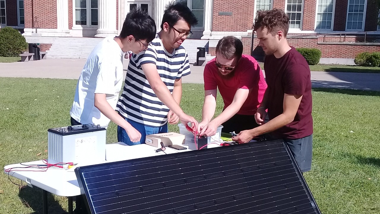 Students work on solar electric energy projects outside at UC.