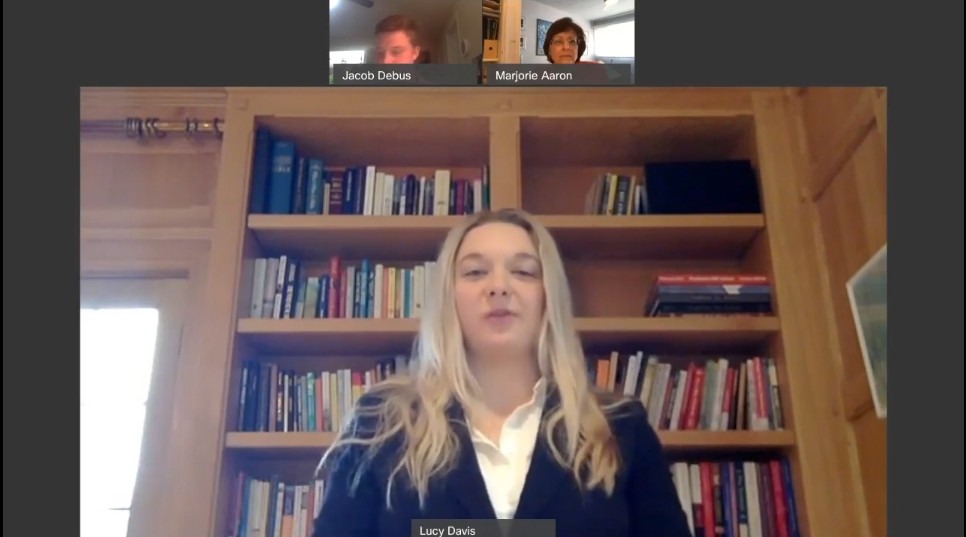 A screenshot of three people shown in split screens using video conferencing software