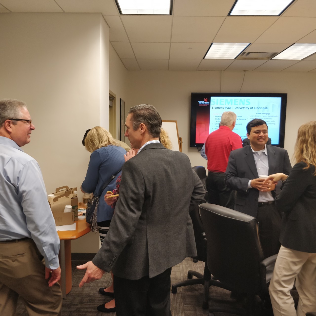 The two groups meeting in a boardroom