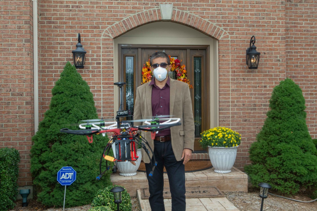 Professor Manish Kumar, PhD, posed with Drone at the home of Dr. Sampsel in West Chester. UC/ Joseph Fuqua II