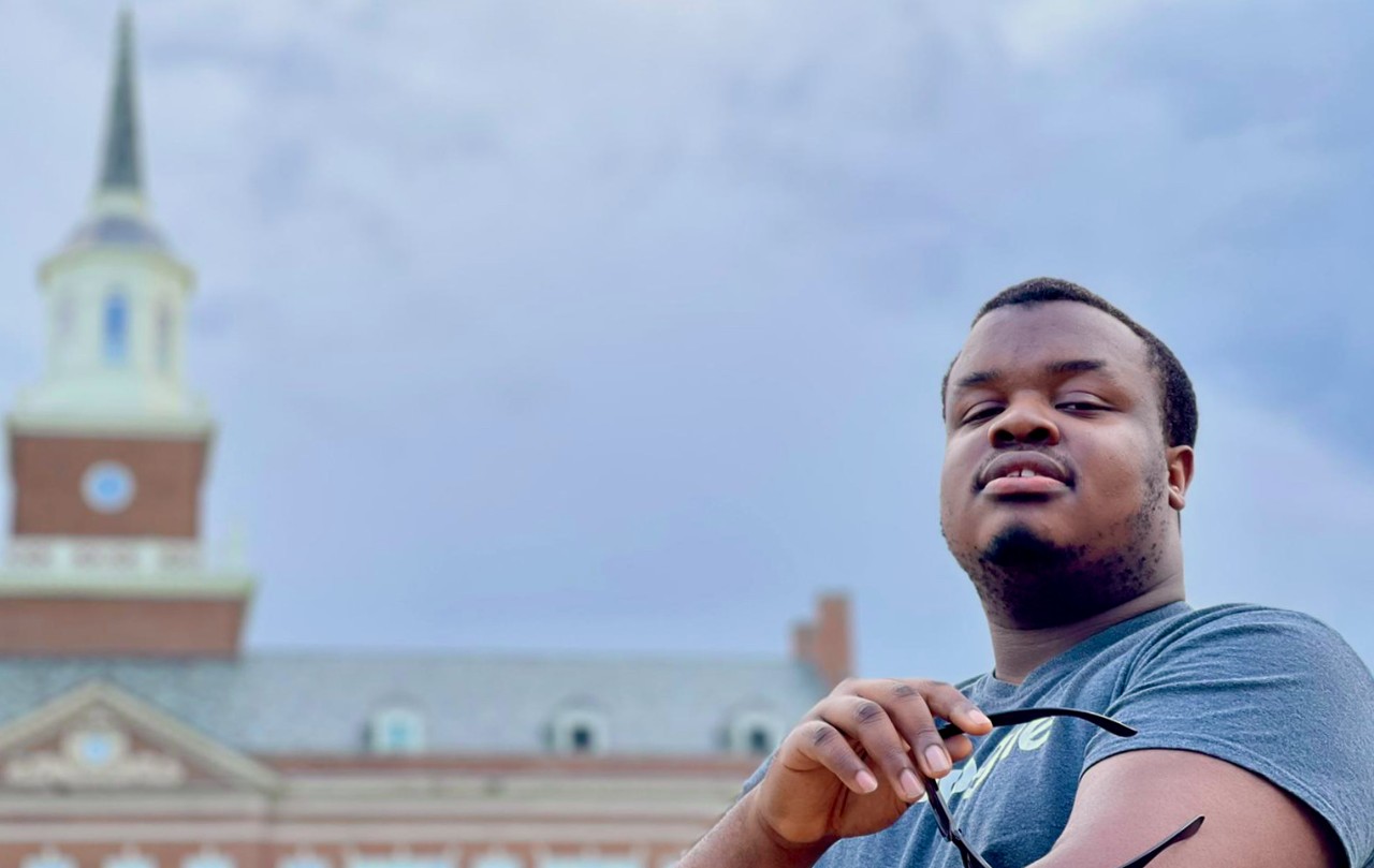 UC's FearGod Okwubido-Williams in front of McMicken Hall bell tower