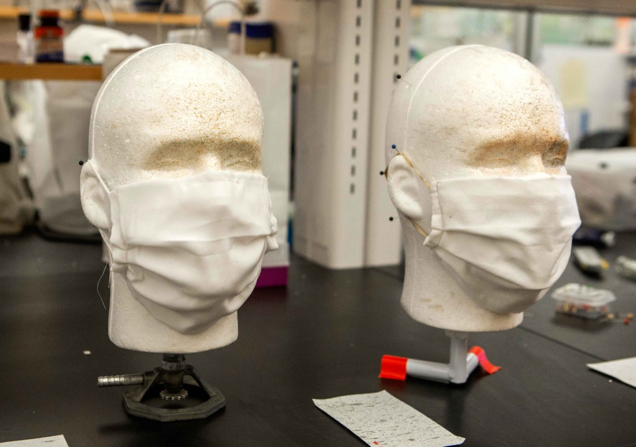 Adam Parlin, UC student shown here with silk mask, left and cloth mask right in his lab at Rieveschl Hall. UC biology professor Patrick Guerra says silk face masks are especially effective barriers, particularly when used in conjunction with N95 masks. UC/ Joseph Fuqua II