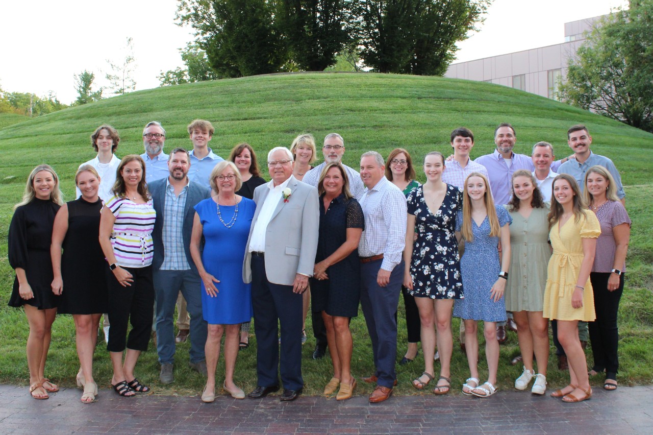a group of 20 members of the Kramer family pose outside