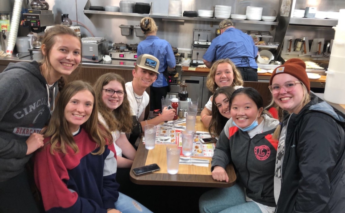 Zhong in a group photo in a booth at the Waffle House