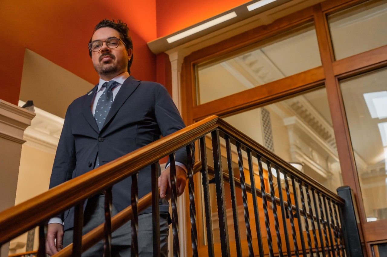 Professor Michael Odio standing on stairs