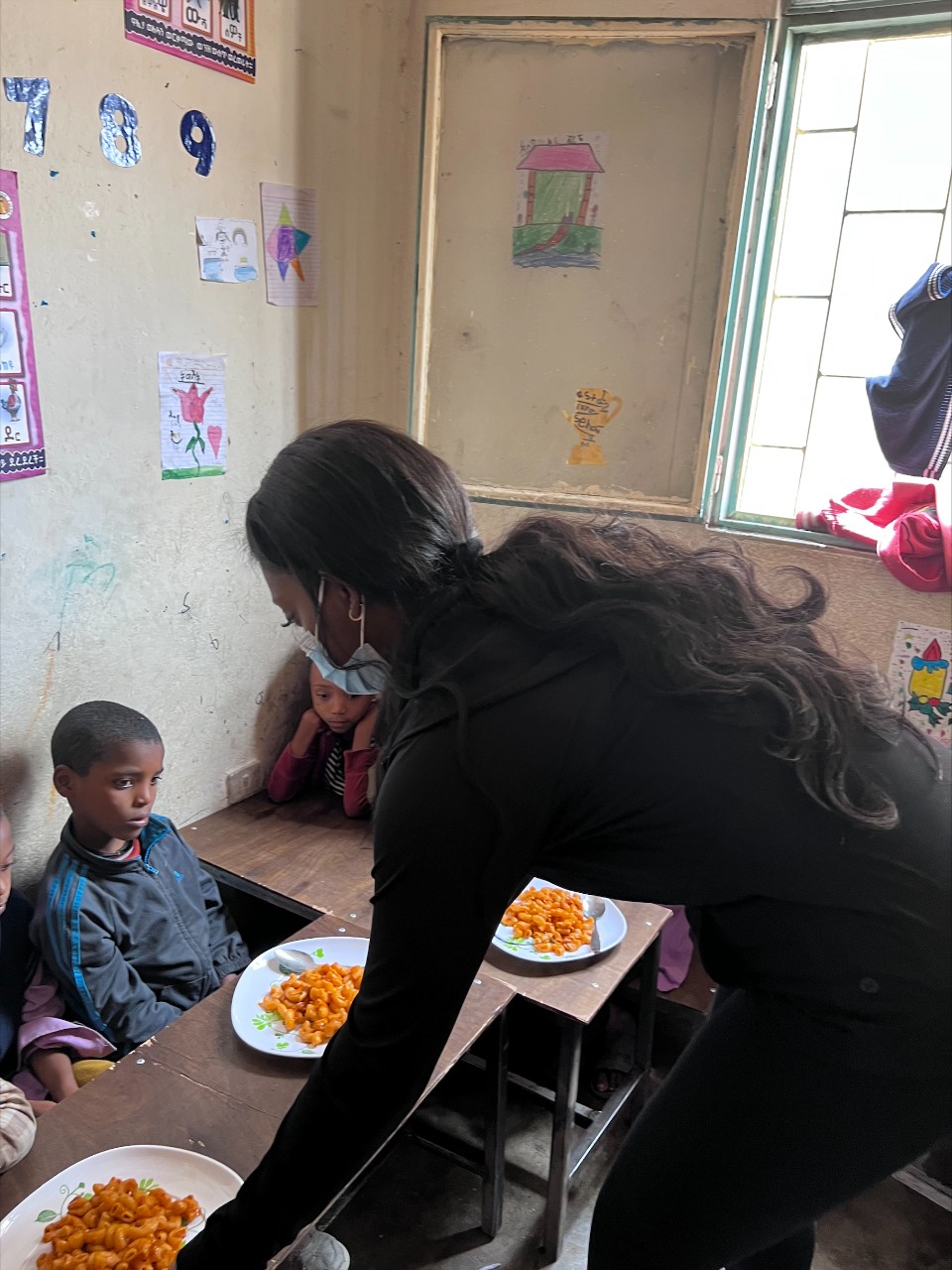 Bitanya Derese helps feed children supported by Korah Kids in Addis Ababa, Ethiopia.