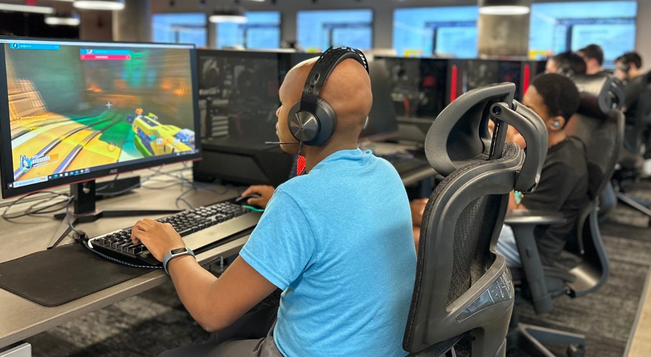 A student plays a video game at the UC Esports Innovation Lab during the Early IT Summer Camp.