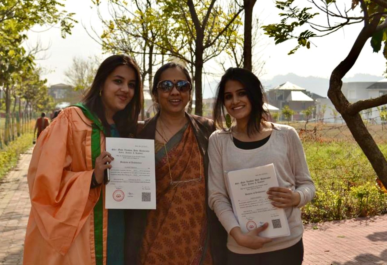 UC DAAP alum Saakshi Terway stands with her mother and sister after her undergraduate commencement ceremony in India.