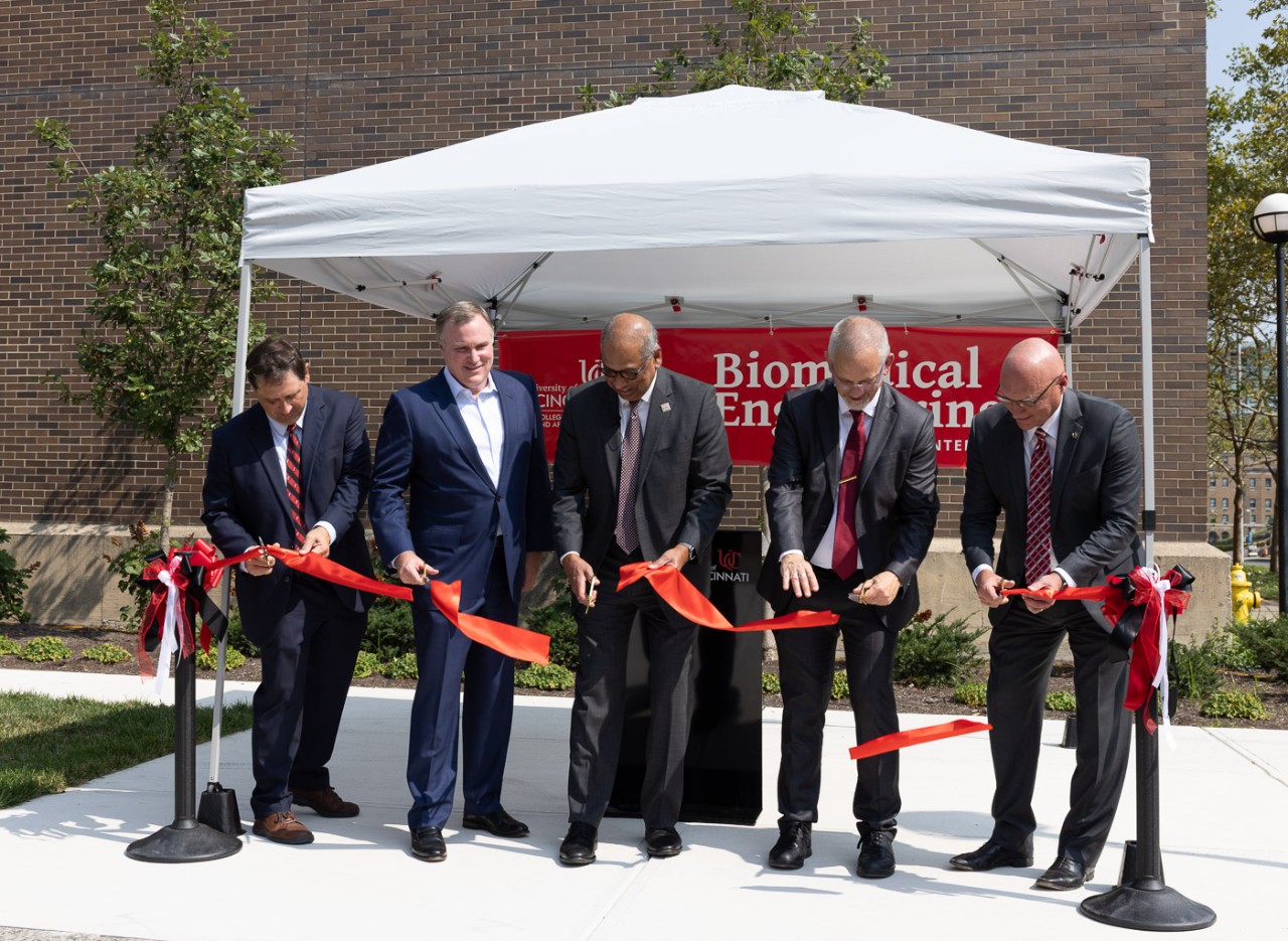 UC dignitaries cut the ribbon in front of a banner that reads Biomedical Engineering.