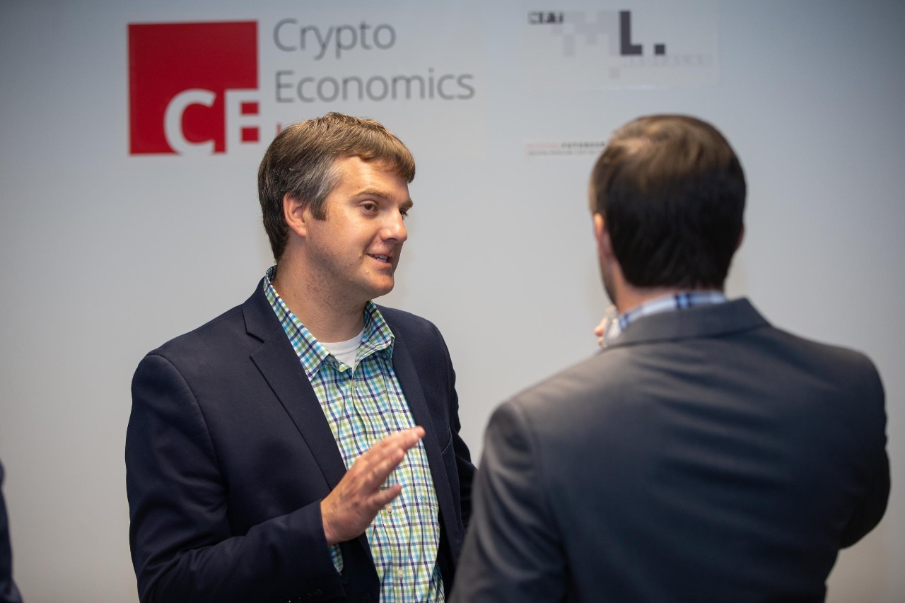 Two men speak together in a lab space.