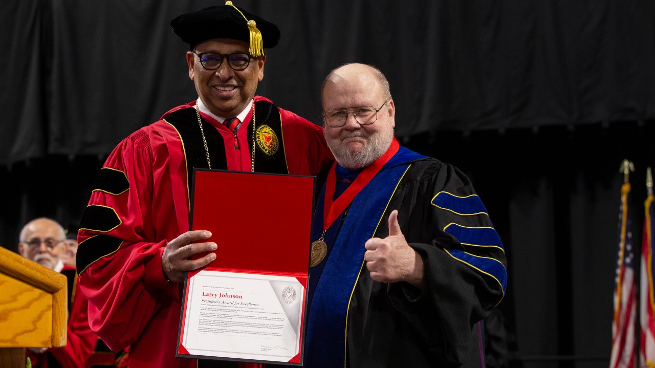 President Pinto presents Dean Johnson with award