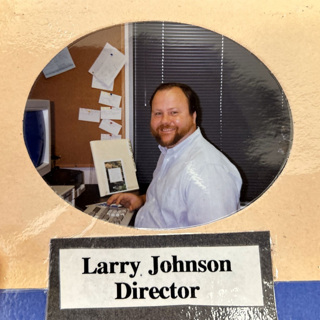 Old picture of Larry Johnson seated at 1990s computer
