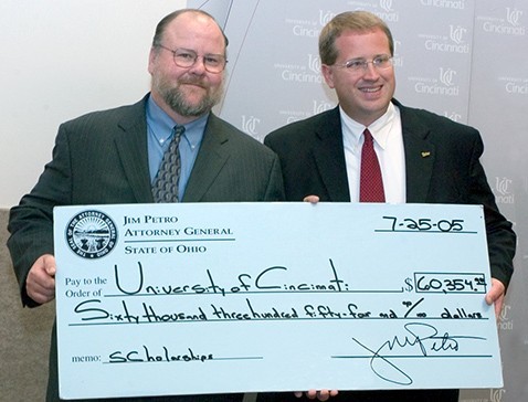 Dean Johnson accepts large check for scholarships