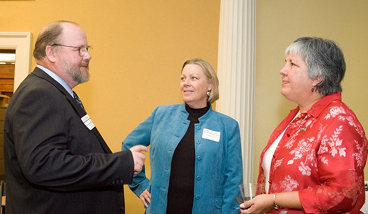 Dean Johnson speaks with two colleagues