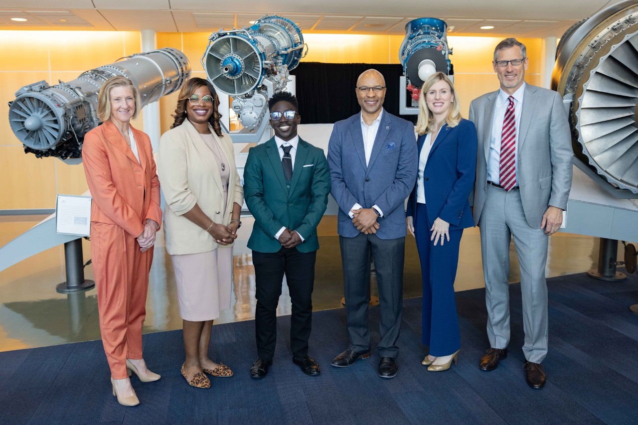 six people in business attire pose