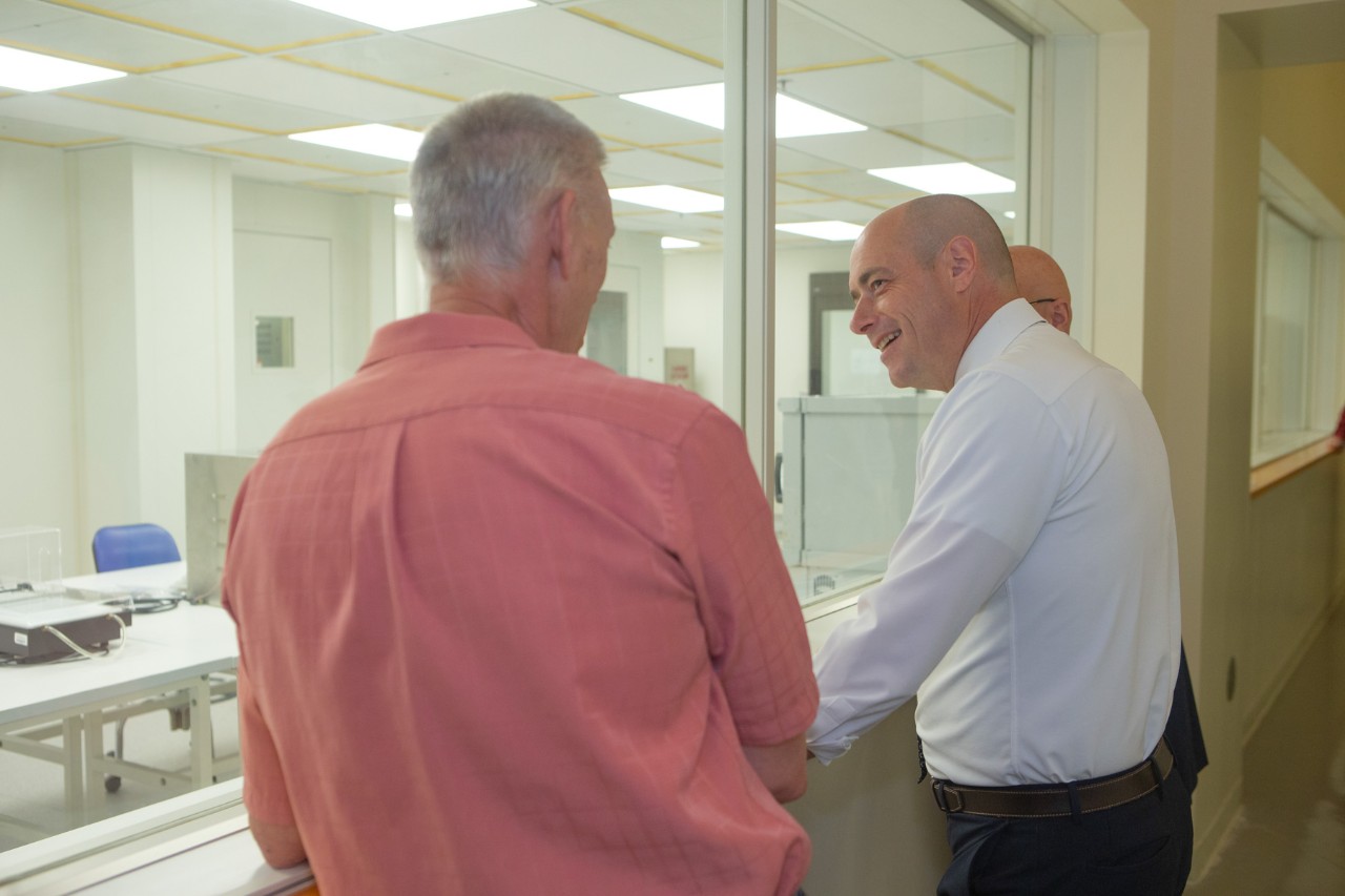 Greg Landsman looks through an observation window at the Mantei Center Cleanroom.