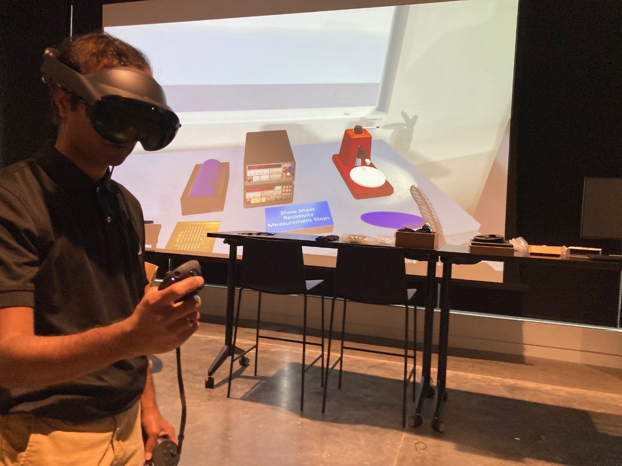 Shailesh Padalkar wears VR goggles while working in a virtual clean room.