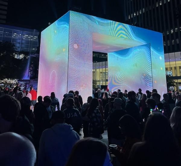 light demonstration in Fountain Square in downtown cincinnati. Big rectangular building on display with lots of lights