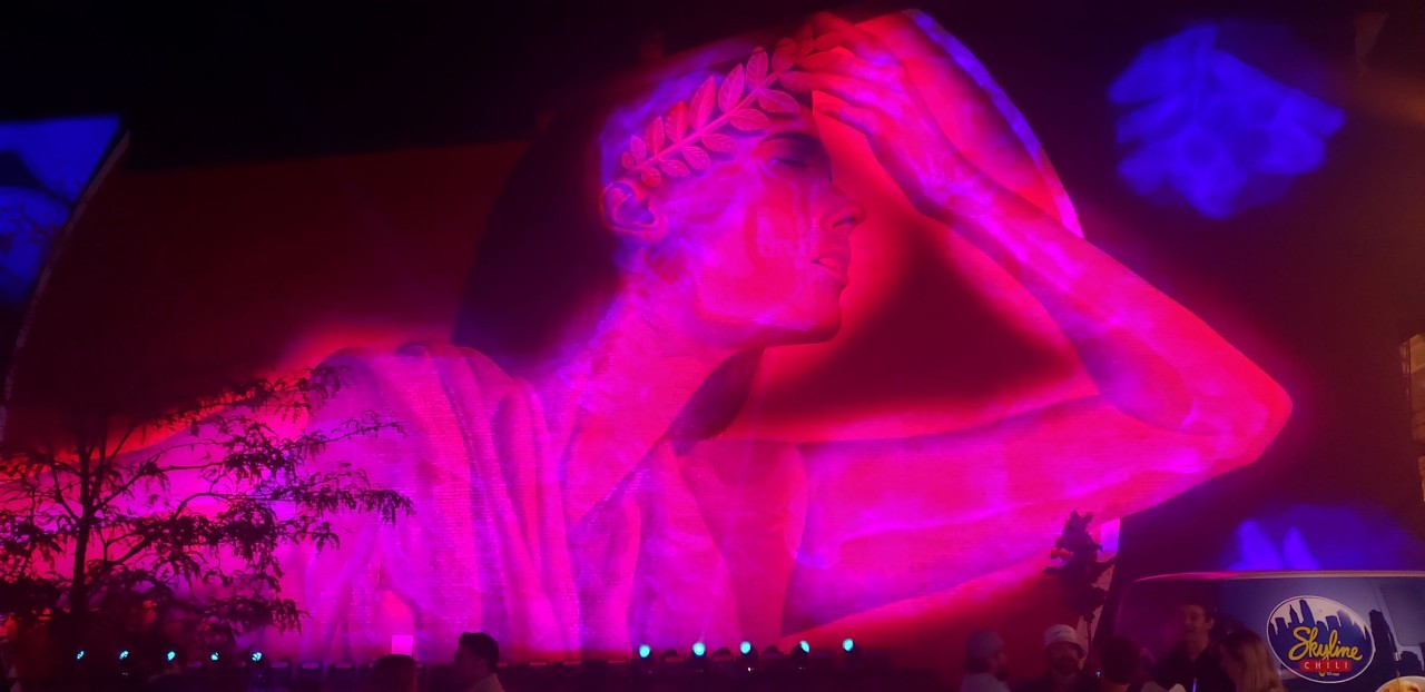light projection on an image of a greek goddess painted on a BLINK mural