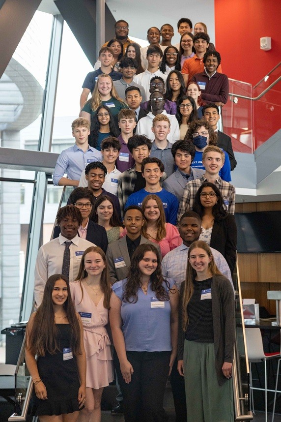 Engineering Academy students stand on the steps of the University of Cincinnati's Nippert pavilion at their graduation ceremony.