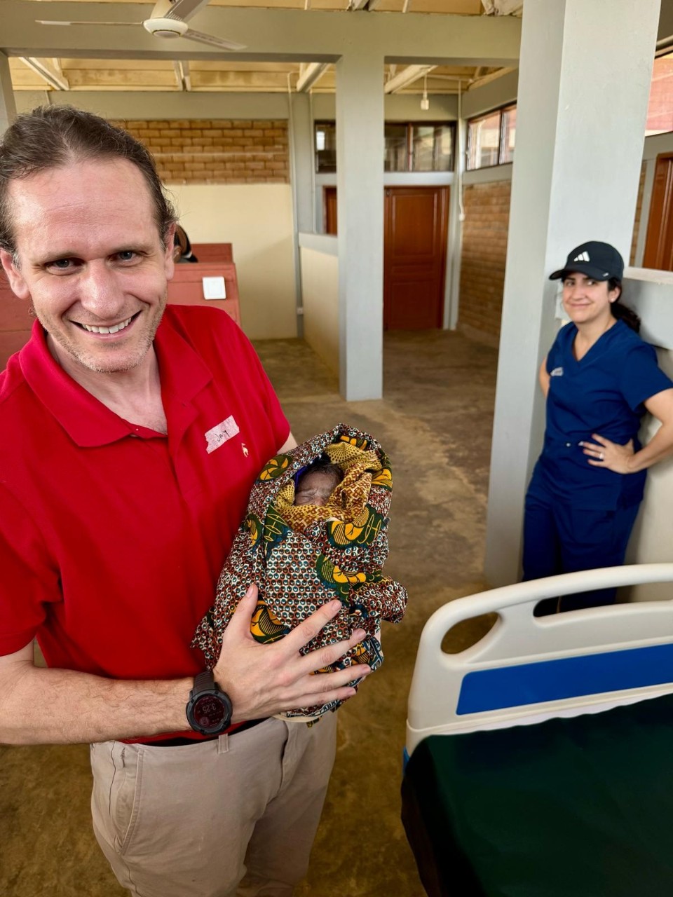 Group photo of UC students and scholars at the M. Anne Haire Reproductive and Child Health Care Center.