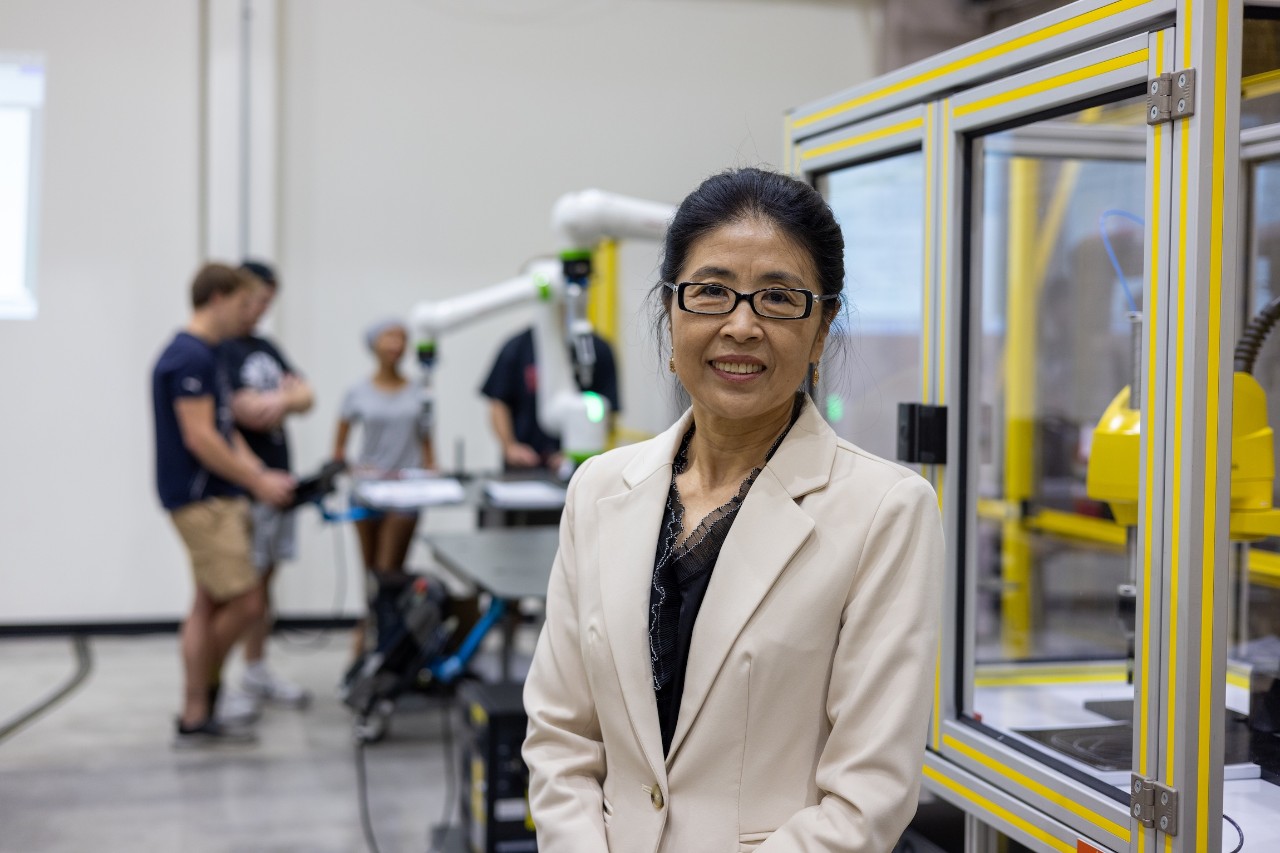 Janet Dong stands in the Robotics and Automation lab