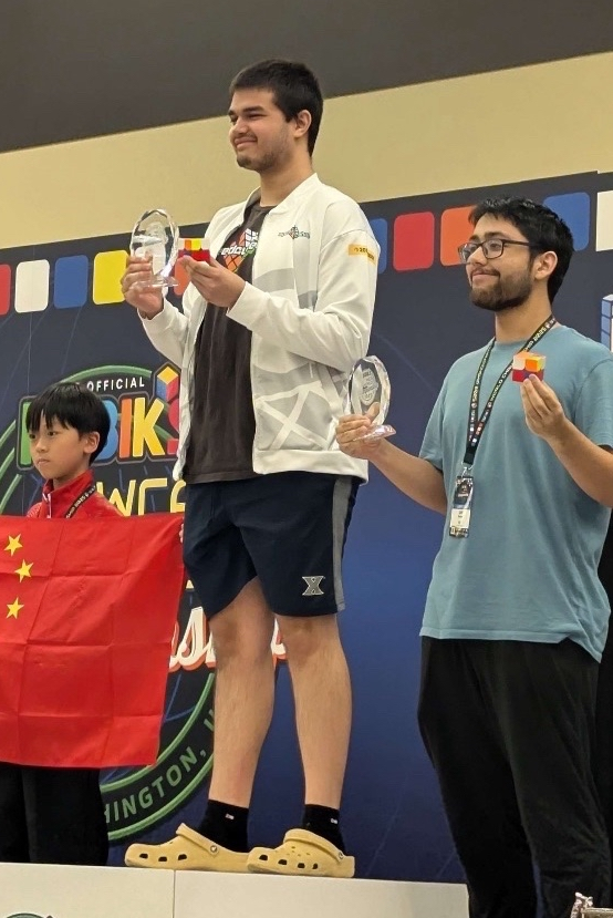Sujan Feist stands at first place on the podium at the Rubik's WCA World Championship.