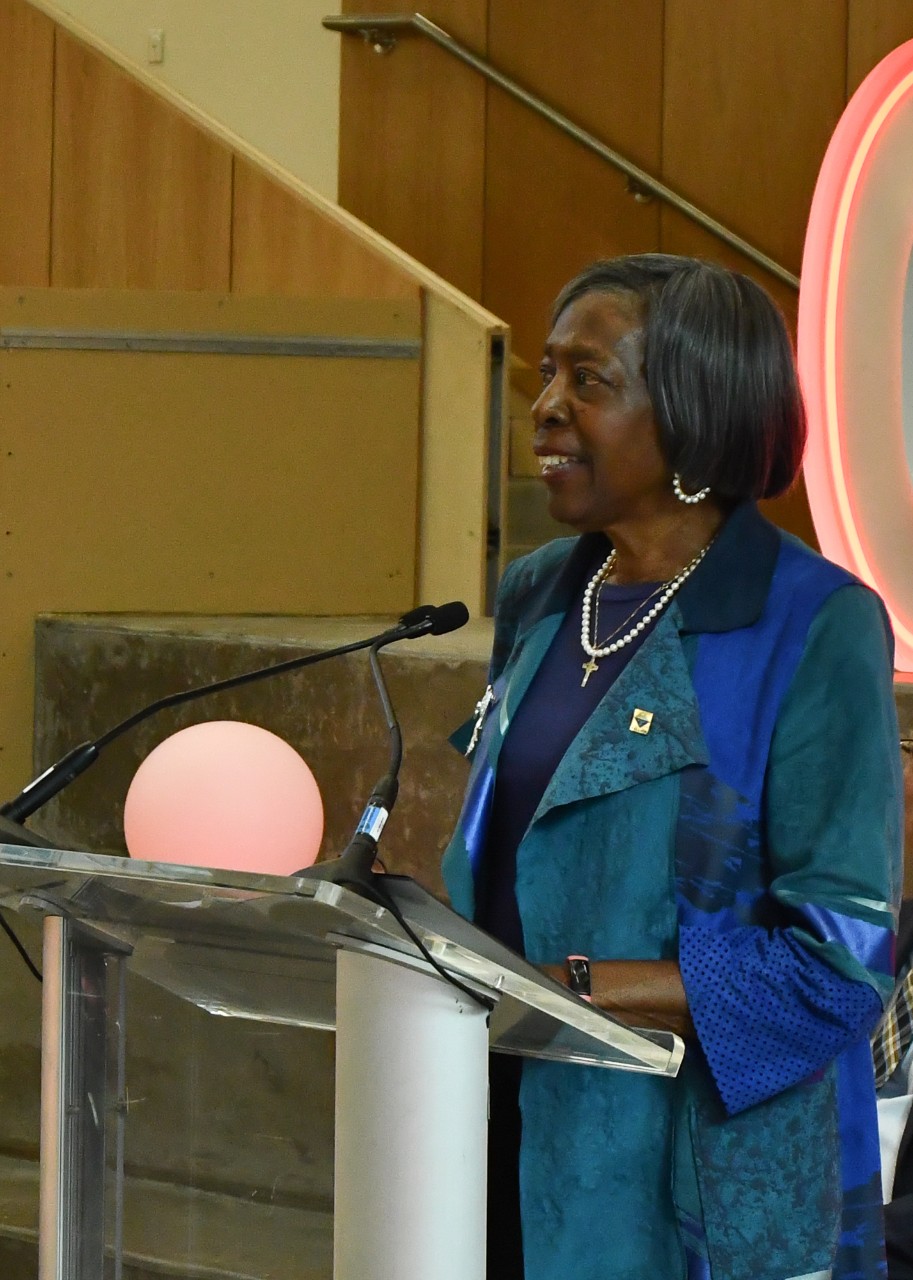 A woman speaks at a podium.